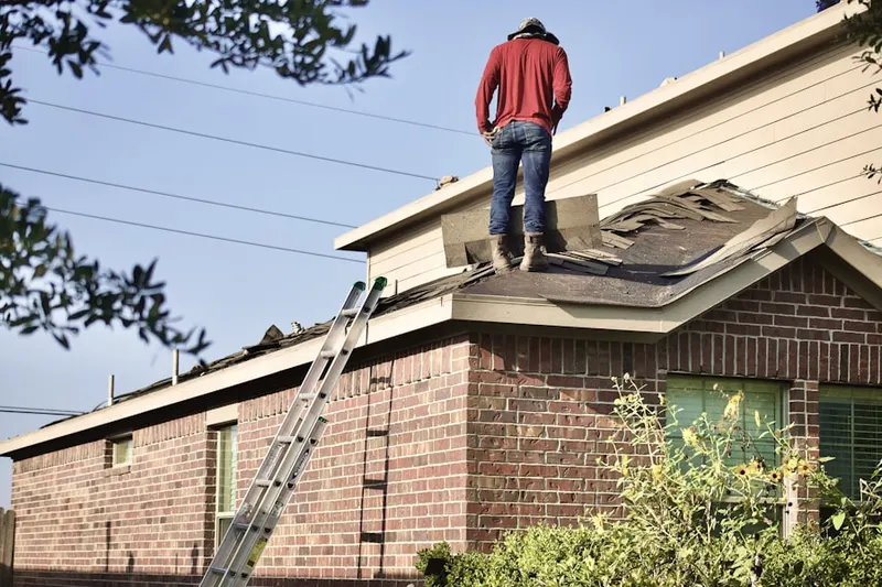 Professional roofer working on a residential roof in Blue Springs Landing